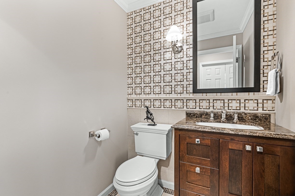 20 Algonquian Drive Natick, MA 01760 - Photo 17 of 40 a bathroom with a granite countertop sink toilet and mirror