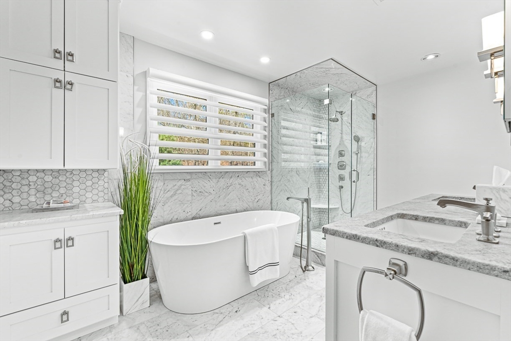 20 Algonquian Drive Natick, MA 01760 - Photo 21 of 40 a bathroom with a granite countertop tub sink and mirror