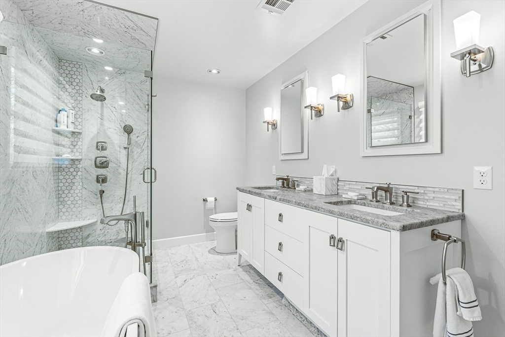 20 Algonquian Drive Natick, MA 01760 - Photo 22 of 40 a bathroom with a granite countertop sink mirror bathtub and toilet