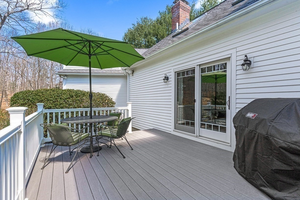 20 Algonquian Drive Natick, MA 01760 - Photo 37 of 40 a deck with a table and chairs under an umbrella