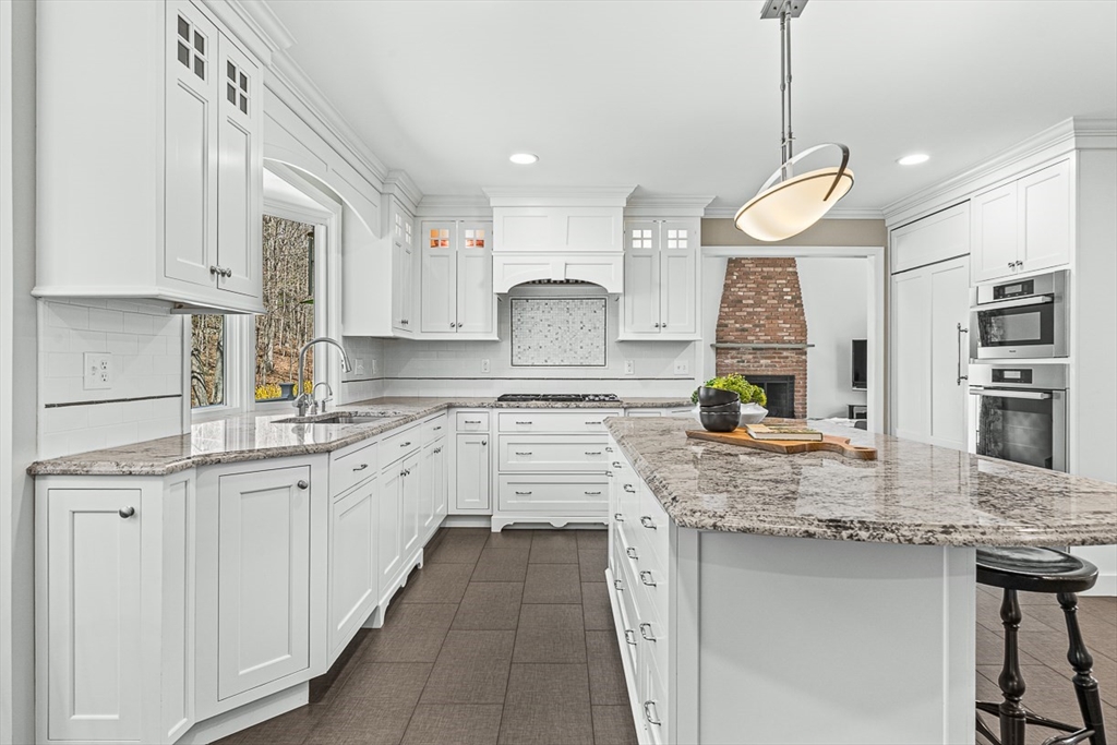 20 Algonquian Drive Natick, MA 01760 - Photo 10 of 40 a kitchen with stainless steel appliances granite countertop a sink a stove and a center island