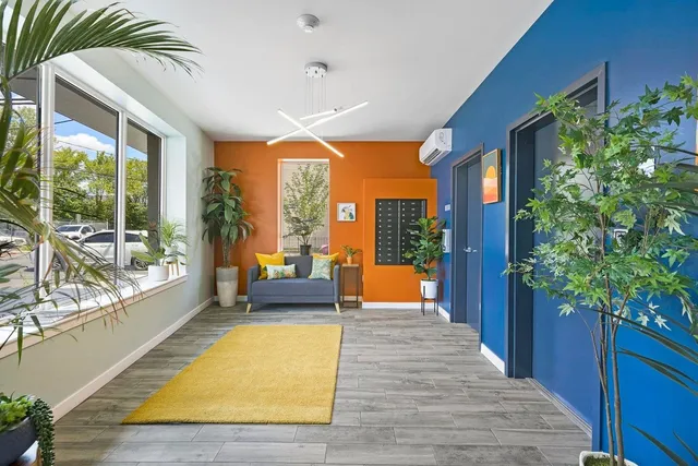 a swimming pool with potted plants and wooden floor