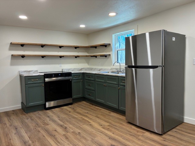 50 Gracy Drive Springville, TN 38256 - Photo 13 of 19 a kitchen with stainless steel appliances wooden cabinets and wooden floor