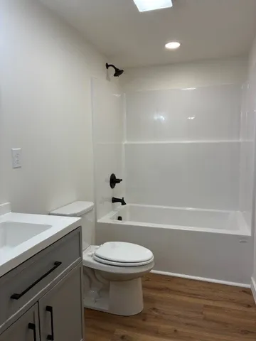 a bathroom with a toilet a sink and bathtub