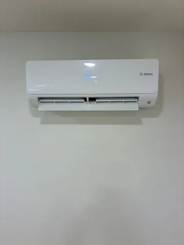 a view of a refrigerator with white wall