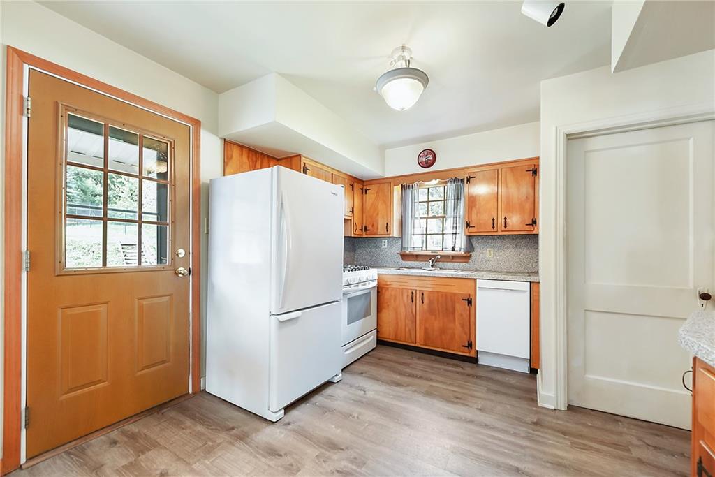 292 Moon Clinton Road Coraopolis, PA 15108 - Photo 11 of 34 a kitchen with granite countertop stainless steel appliances a refrigerator cabinets and wooden floor