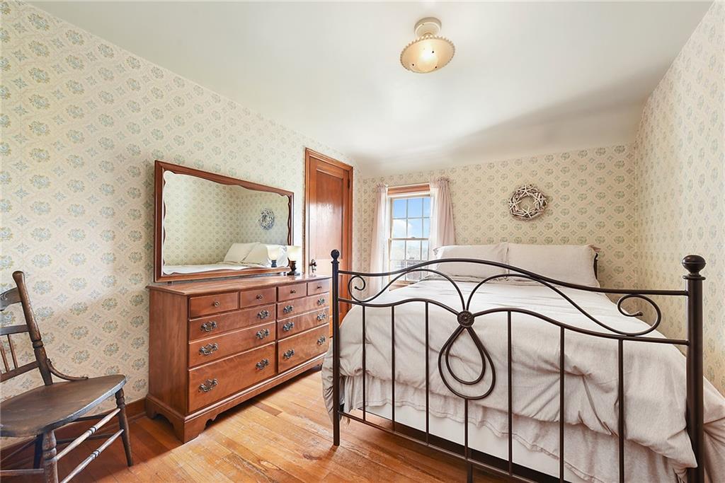 292 Moon Clinton Road Coraopolis, PA 15108 - Photo 18 of 34 a bedroom with a bed and a chandelier