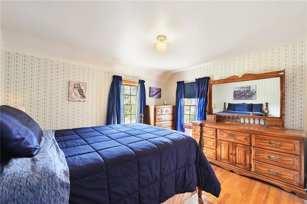 292 Moon Clinton Road Coraopolis, PA 15108 - Photo 19 of 34 a bedroom with a bed and dresser with mirror