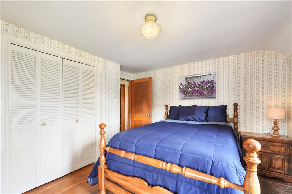 292 Moon Clinton Road Coraopolis, PA 15108 - Photo 20 of 34 a bedroom with a bed and wooden floor