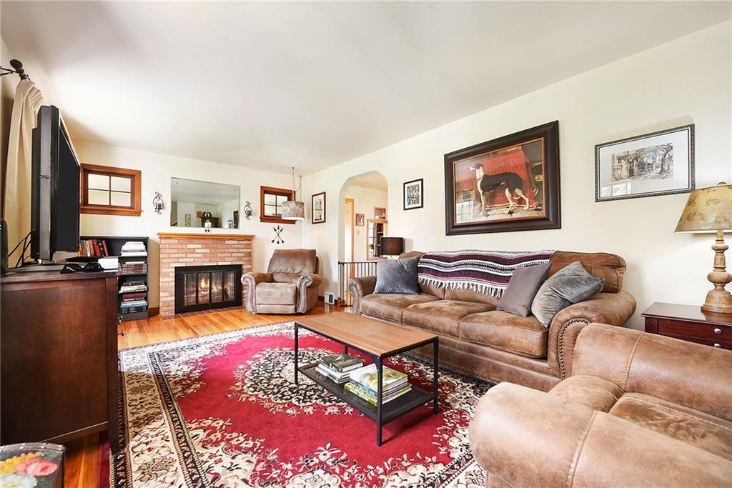 292 Moon Clinton Road Coraopolis, PA 15108 - Photo 2 of 34 a living room with furniture a fireplace and a flat screen tv