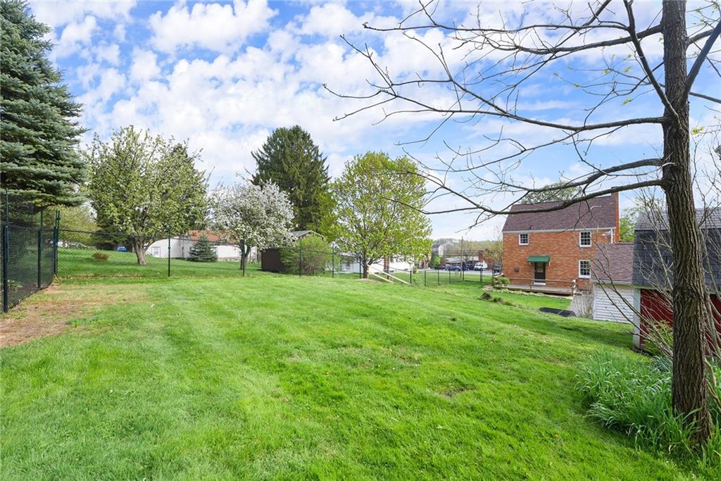 292 Moon Clinton Road Coraopolis, PA 15108 - Photo 34 of 34 a backyard of a house with plants and large trees