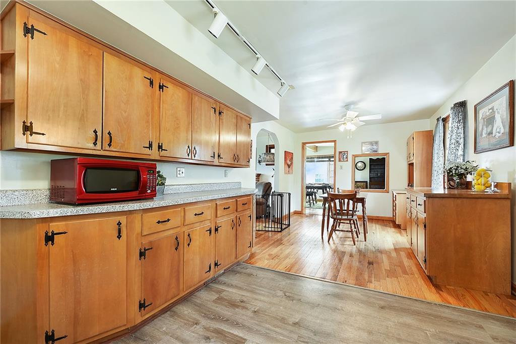 292 Moon Clinton Road Coraopolis, PA 15108 - Photo 9 of 34 a kitchen with stainless steel appliances granite countertop wooden floors a stove and white cabinets