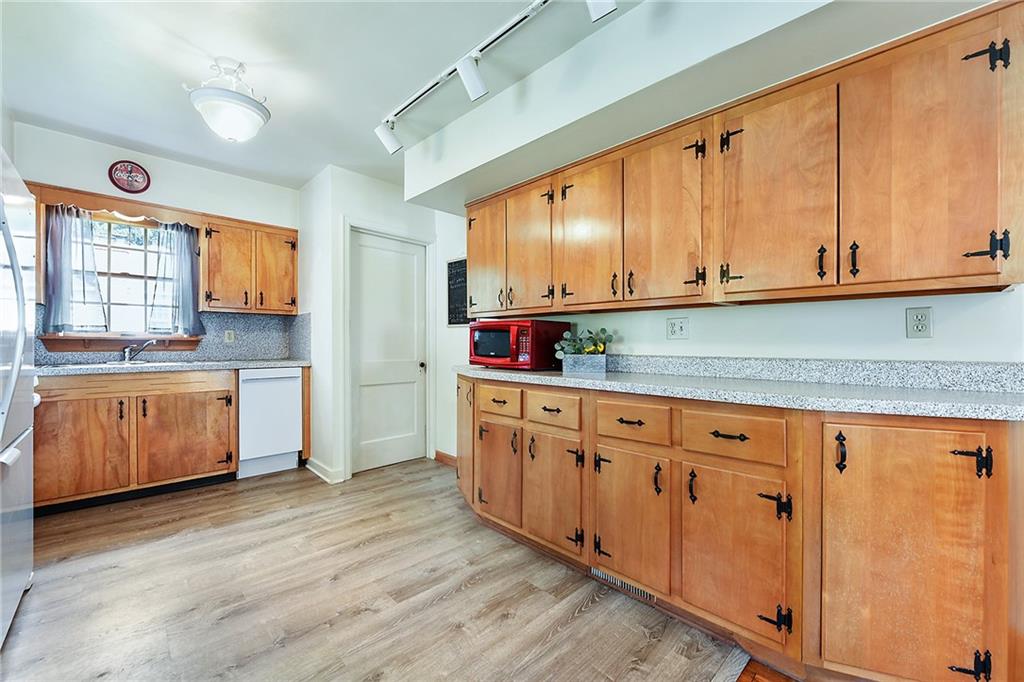 292 Moon Clinton Road Coraopolis, PA 15108 - Photo 10 of 34 a kitchen with granite countertop a sink cabinets stainless steel appliances and a window