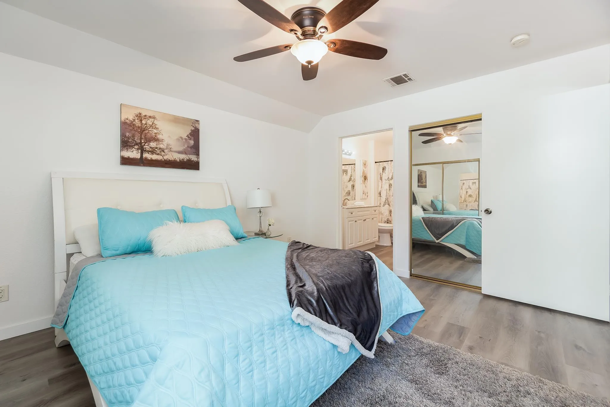 6111 Rancho Mission Road, Unit 101 San Diego, CA 92108 - Photo 12 of 30 a bedroom with a bed and a chandelier