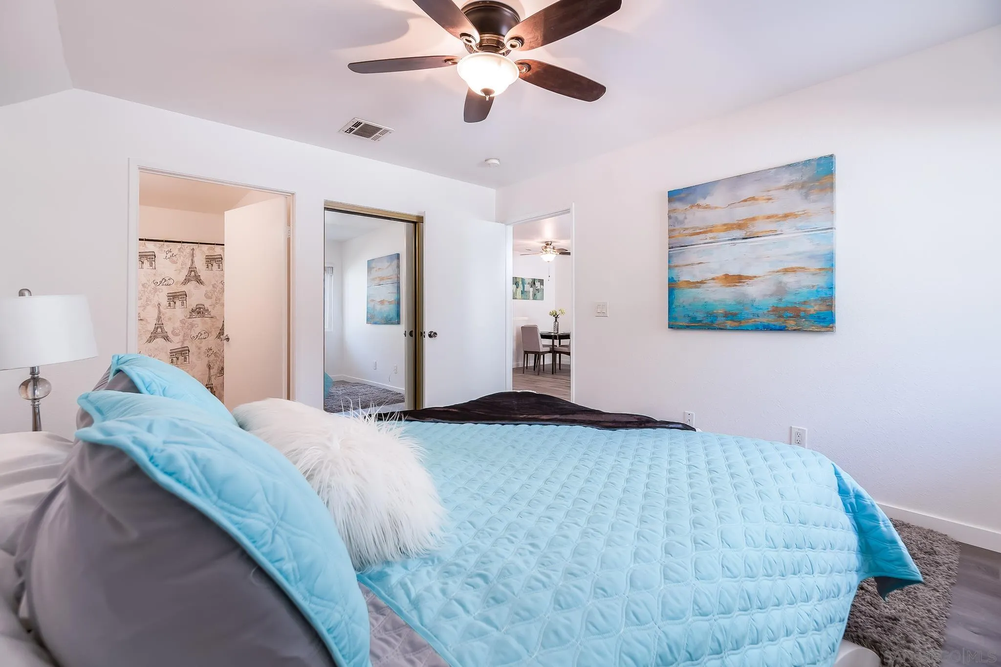 6111 Rancho Mission Road, Unit 101 San Diego, CA 92108 - Photo 13 of 30 a bedroom with a bed and a chandelier