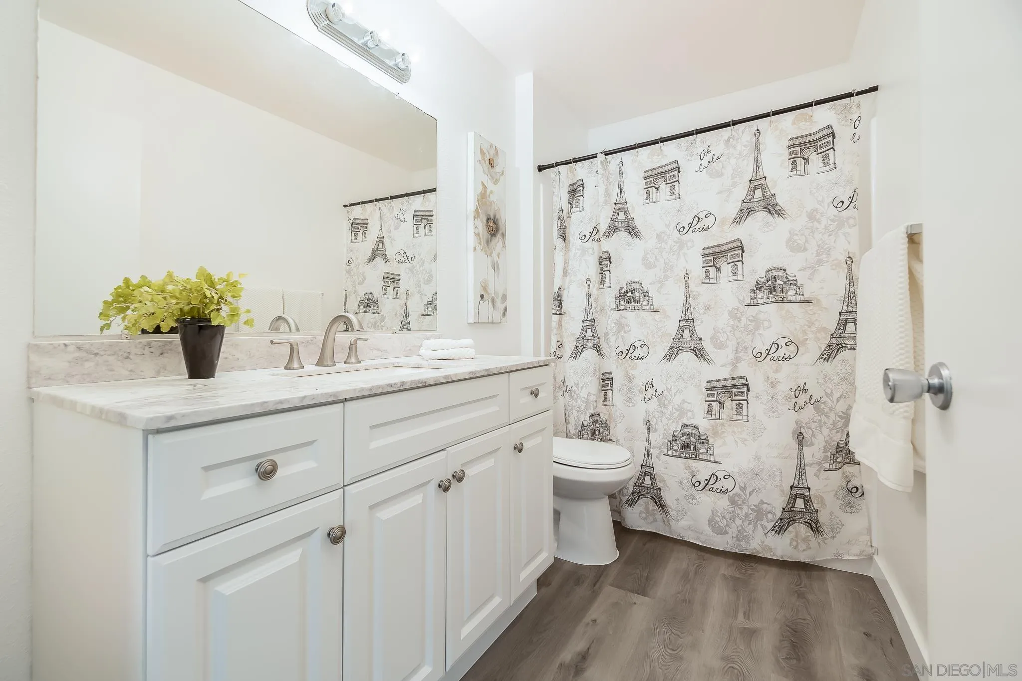 6111 Rancho Mission Road, Unit 101 San Diego, CA 92108 - Photo 14 of 30 a bathroom with a sink a toilet and shower curtain