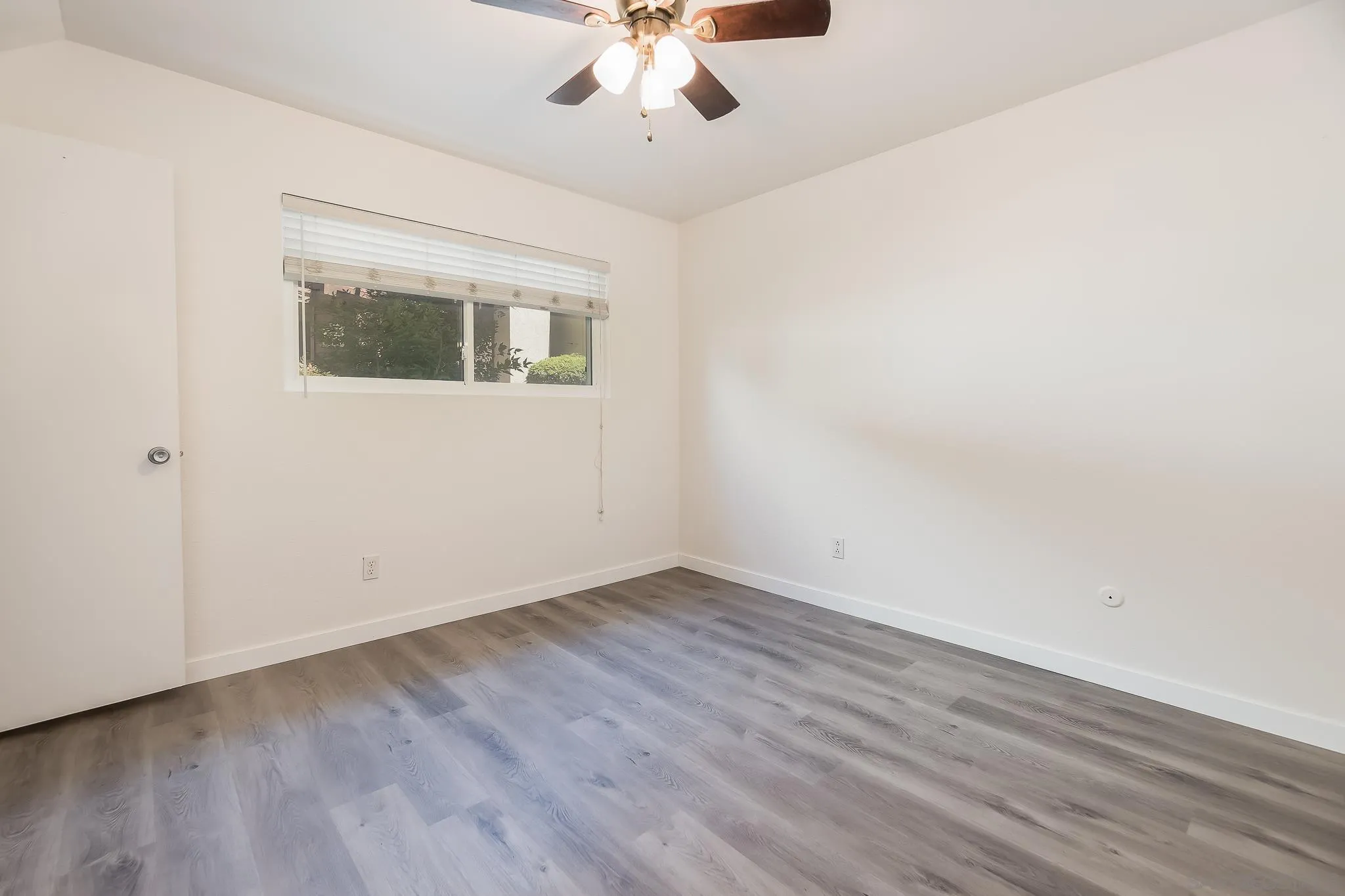 6111 Rancho Mission Road, Unit 101 San Diego, CA 92108 - Photo 15 of 30 wooden floor in an empty room with a window