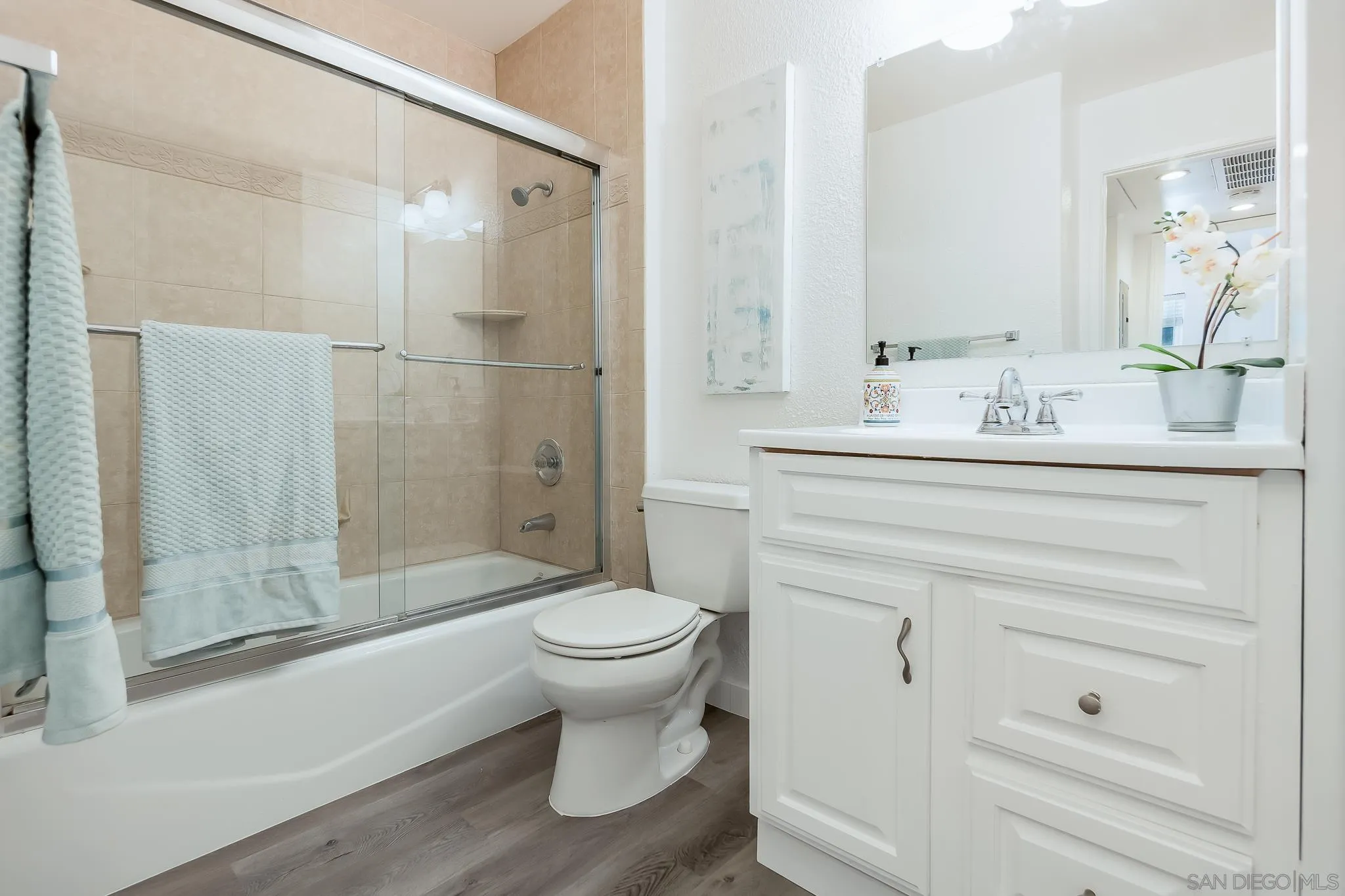 6111 Rancho Mission Road, Unit 101 San Diego, CA 92108 - Photo 17 of 30 a bathroom with a sink toilet a mirror and shower