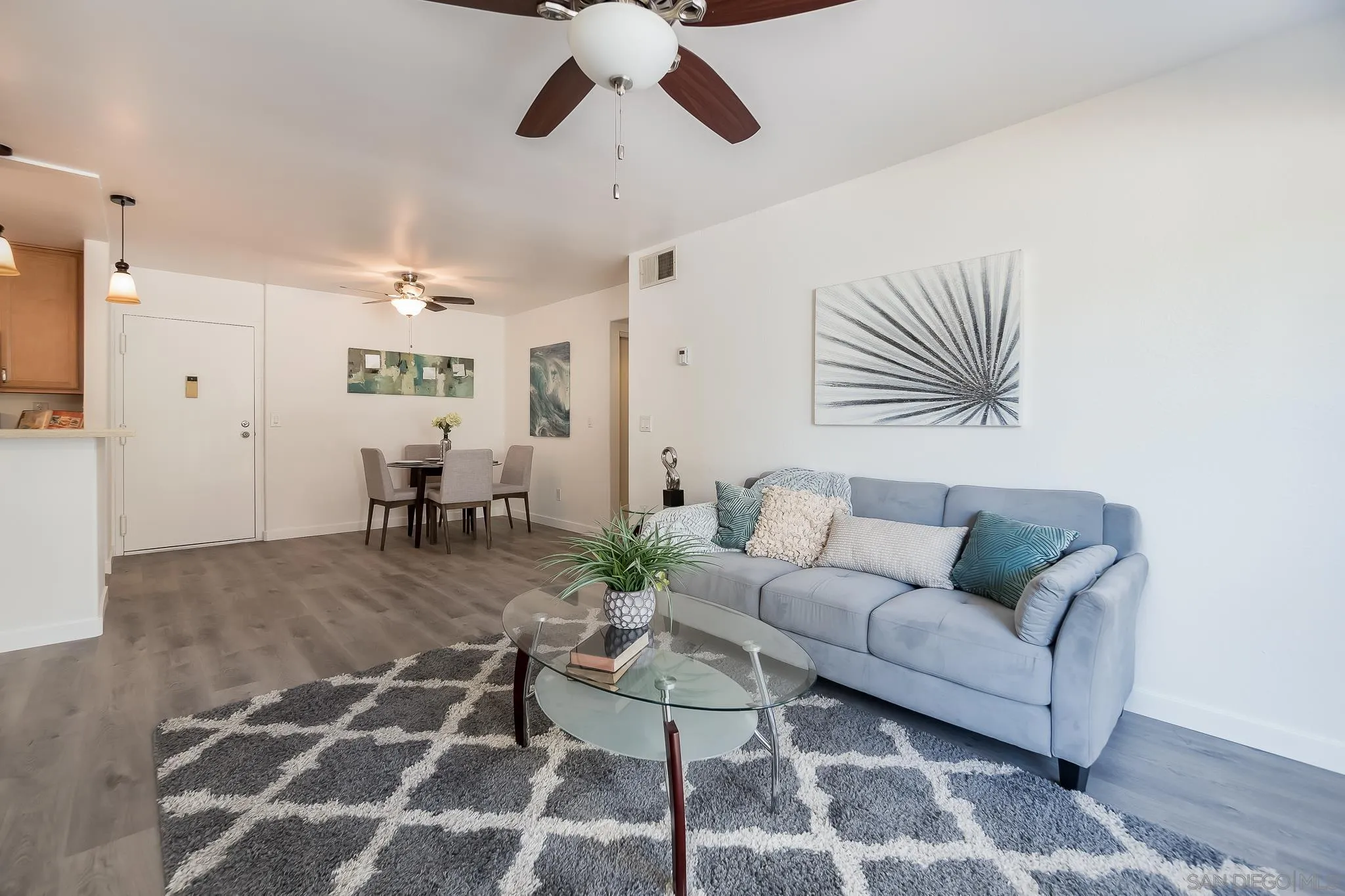 6111 Rancho Mission Road, Unit 101 San Diego, CA 92108 - Photo 4 of 30 a living room with furniture and wooden floor