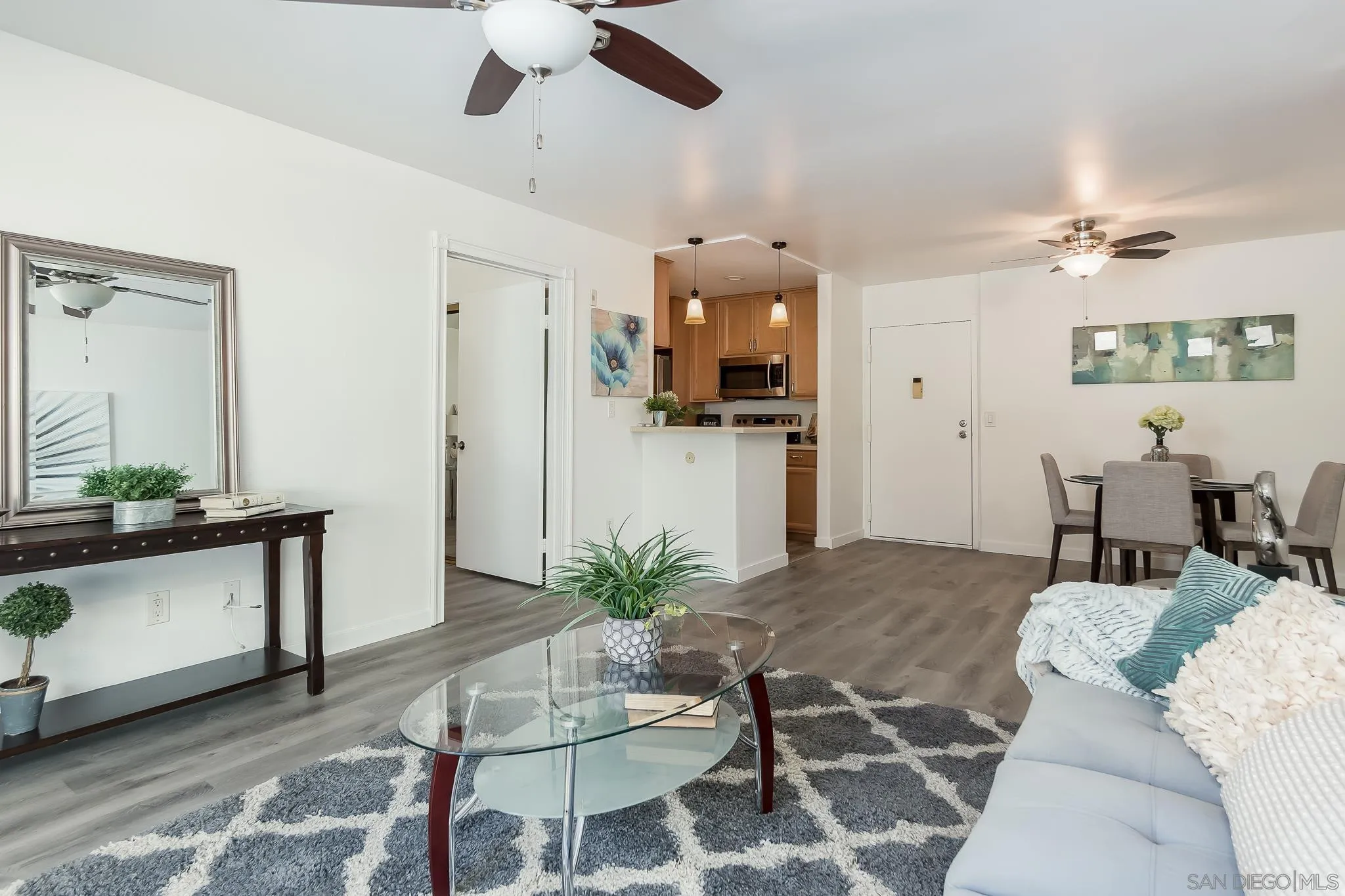 6111 Rancho Mission Road, Unit 101 San Diego, CA 92108 - Photo 5 of 30 a living room with furniture and a wooden floor