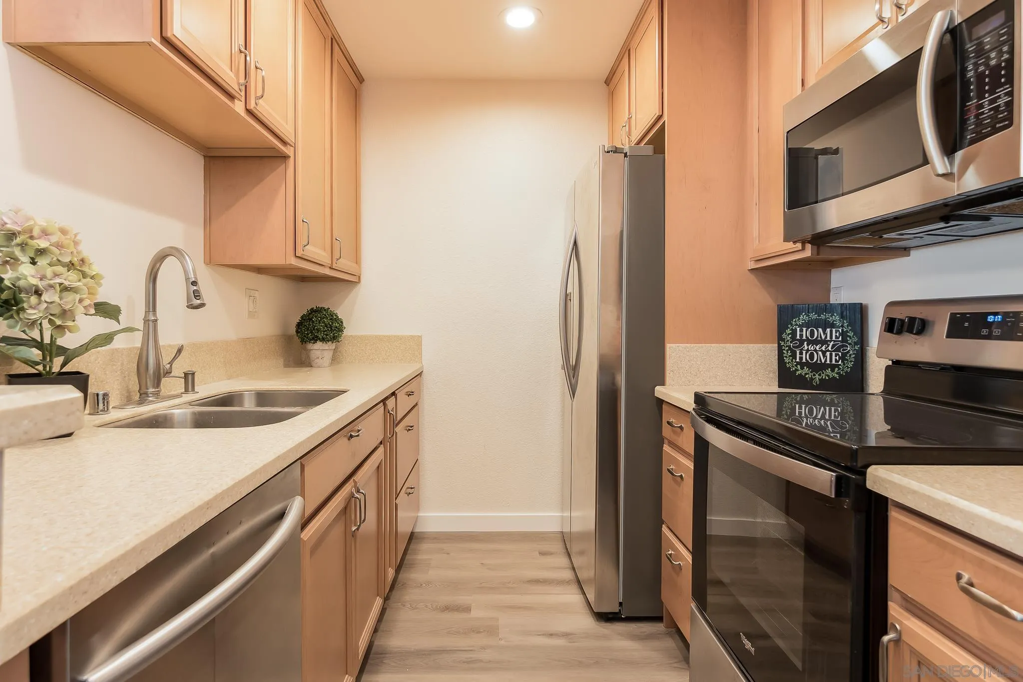 6111 Rancho Mission Road, Unit 101 San Diego, CA 92108 - Photo 7 of 30 a kitchen with stainless steel appliances granite countertop a sink stove and refrigerator