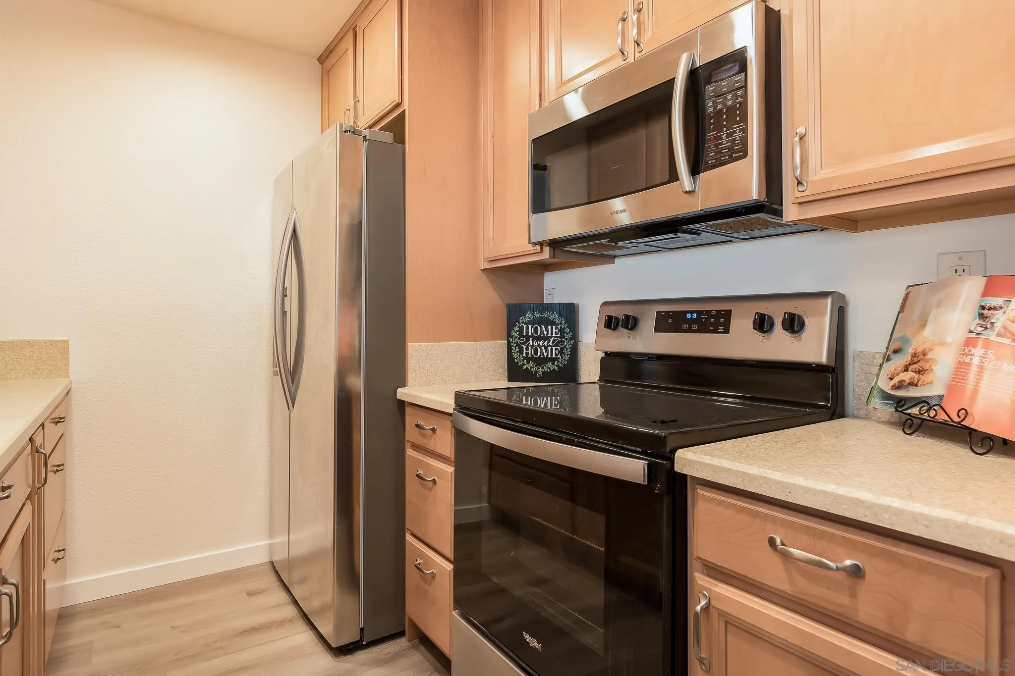 6111 Rancho Mission Road, Unit 101 San Diego, CA 92108 - Photo 8 of 30 a kitchen with a stove and a microwave