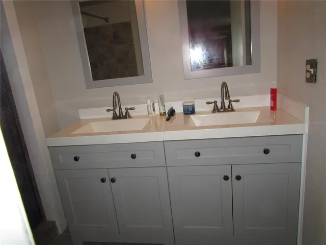 a bathroom with a granite countertop toilet and a sink