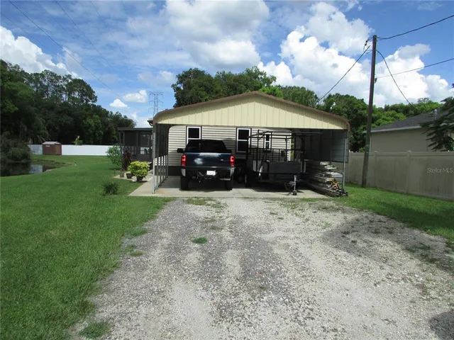 a view of house with backyard space and garden