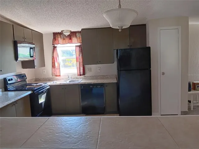 a kitchen with a refrigerator and a sink