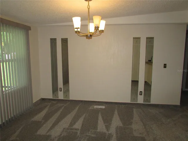 a kitchen with a sink refrigerator and window