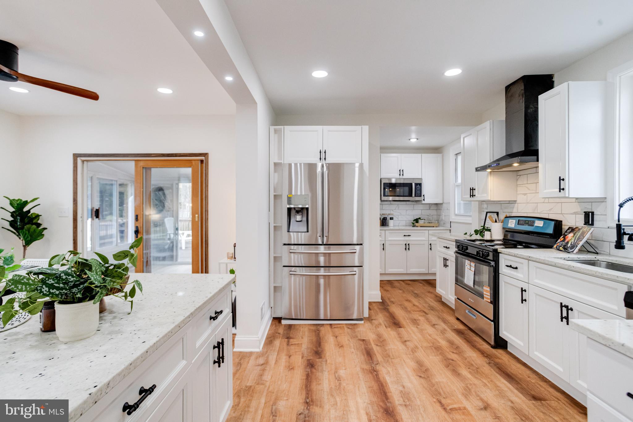 7932 Philadelphia Road Baltimore, MD 21237 - Photo 12 of 44 a kitchen with granite countertop a refrigerator and a sink