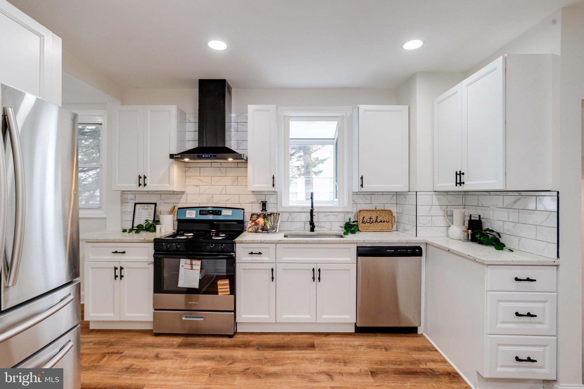 7932 Philadelphia Road Baltimore, MD 21237 - Photo 13 of 44 a kitchen with stainless steel appliances granite countertop a stove and a refrigerator