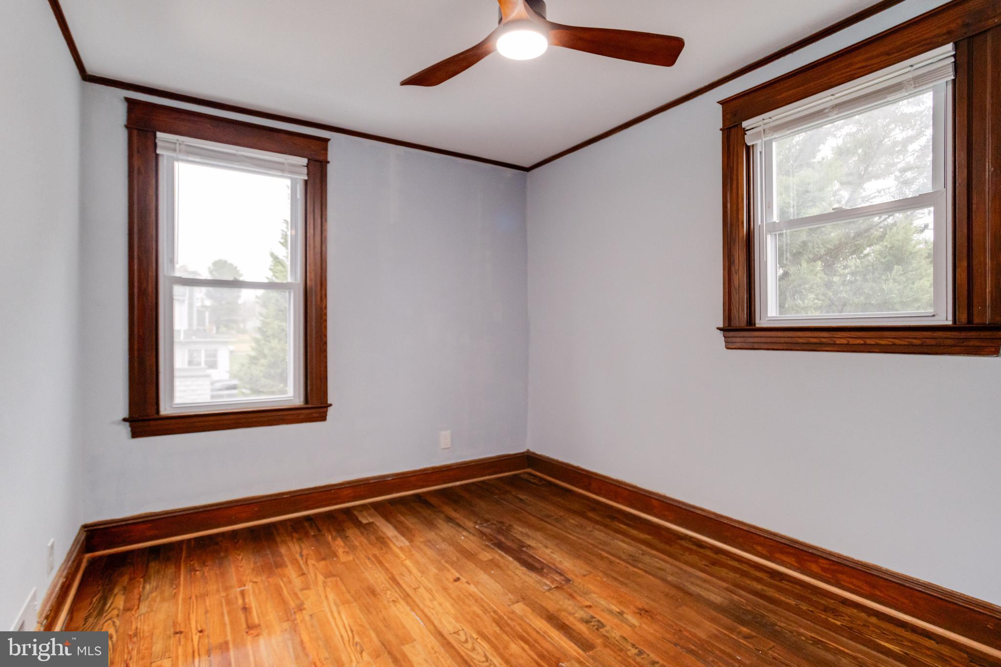 7932 Philadelphia Road Baltimore, MD 21237 - Photo 24 of 44 a view of an empty room with wooden floor and a window