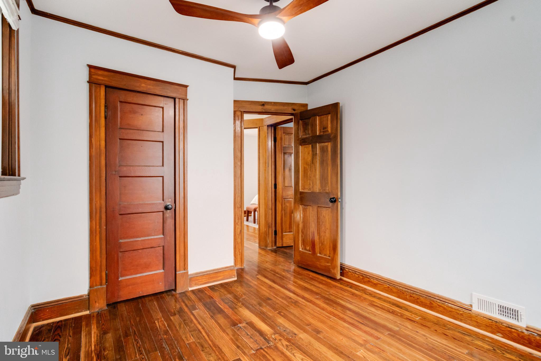 7932 Philadelphia Road Baltimore, MD 21237 - Photo 25 of 44 a view of an empty room with wooden floor and a window