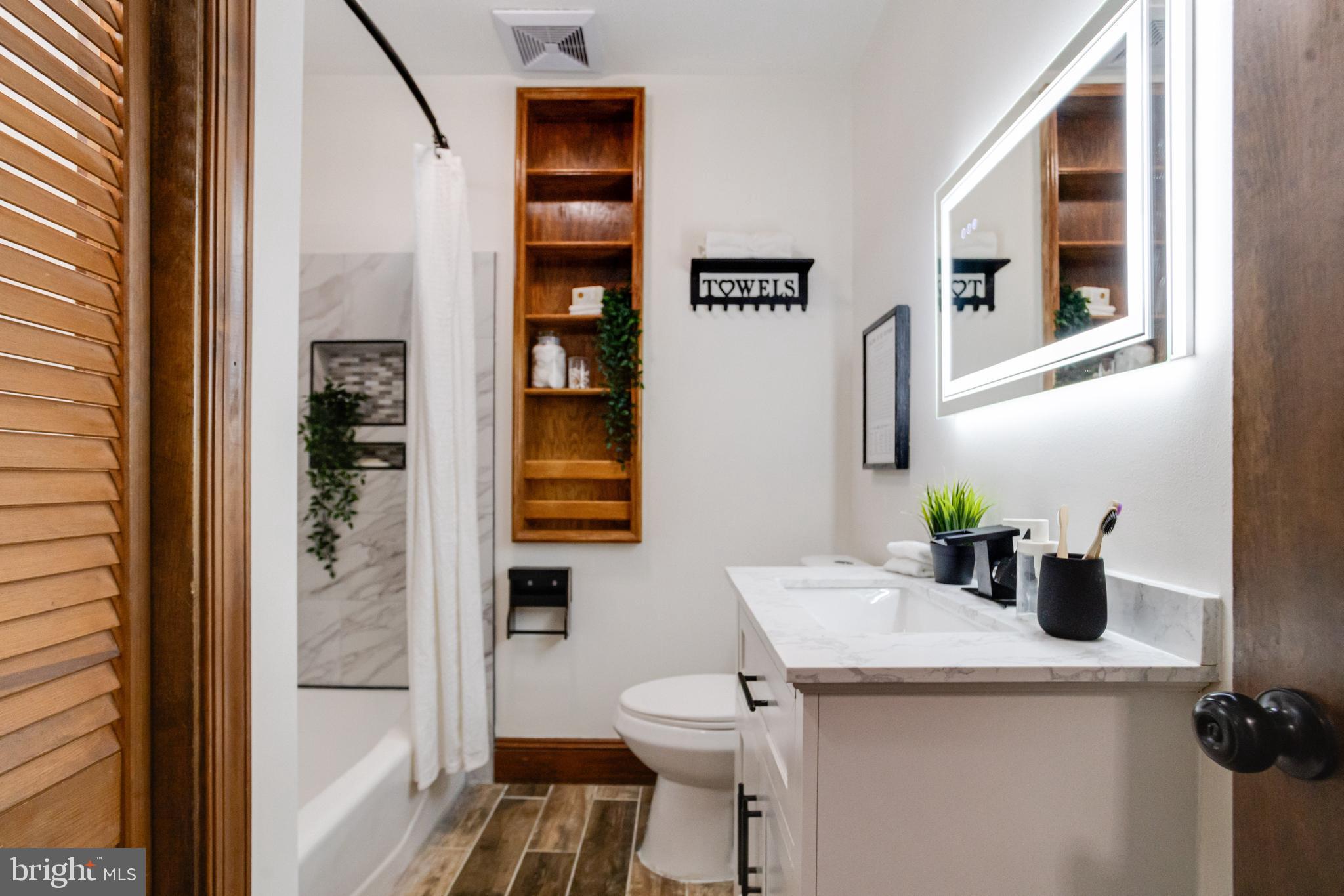 7932 Philadelphia Road Baltimore, MD 21237 - Photo 26 of 44 a bathroom with a sink a toilet and shower