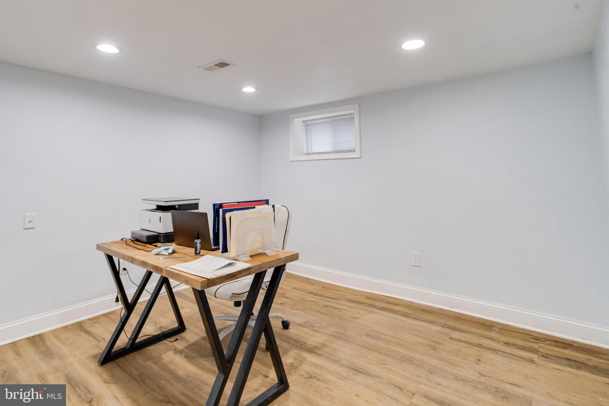 7932 Philadelphia Road Baltimore, MD 21237 - Photo 30 of 44 a workspace with furniture and wooden floor