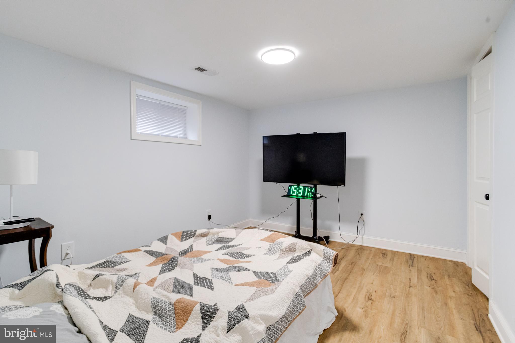7932 Philadelphia Road Baltimore, MD 21237 - Photo 33 of 44 a bedroom with a bed and a flat screen tv