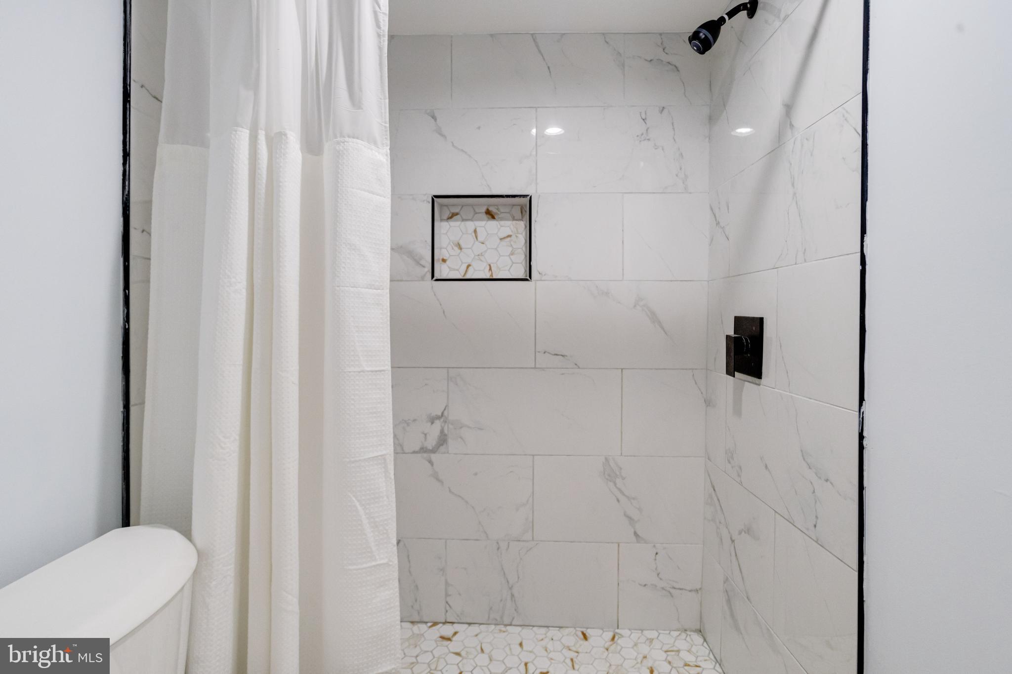 7932 Philadelphia Road Baltimore, MD 21237 - Photo 36 of 44 a bathroom with a toilet and a shower