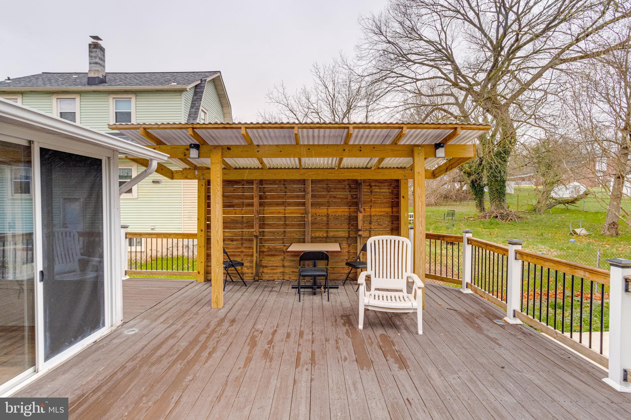 7932 Philadelphia Road Baltimore, MD 21237 - Photo 38 of 44 a roof deck with table and chairs and wooden floor