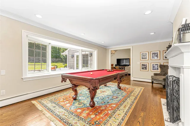 a room with pool table and windows