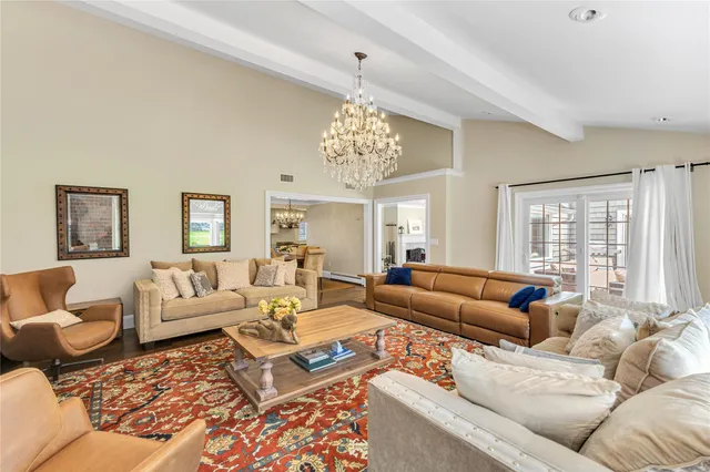 a living room with furniture or couch and a chandelier