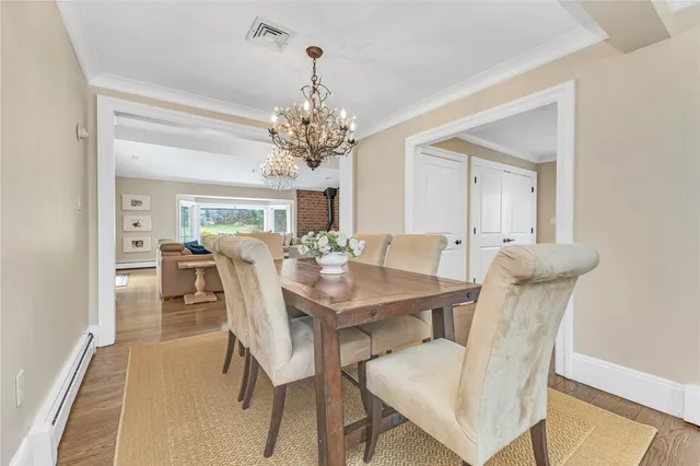 a view of a dining room with furniture and chandelier