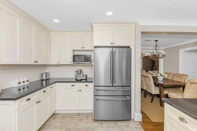 a kitchen with a refrigerator and a sink