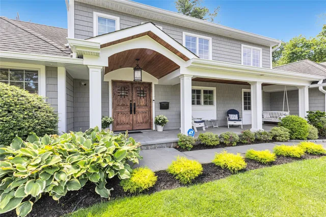 a view of a house with swimming pool and porch