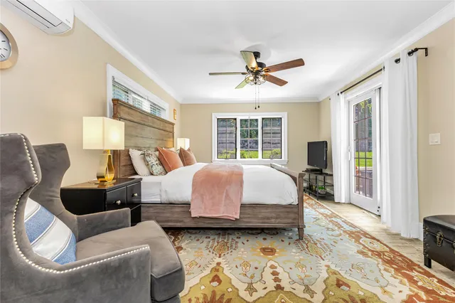 a spacious bedroom with a bed a couch and a window