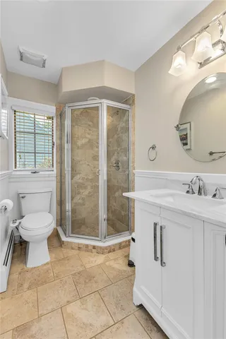 a bathroom with a toilet sink and shower