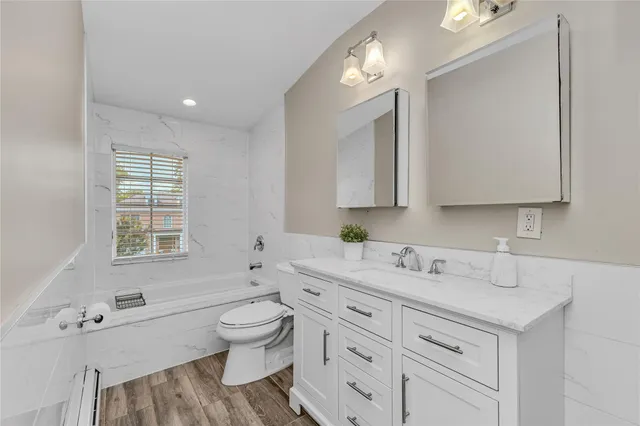 a spacious bathroom with double vanity a toilet a and a window