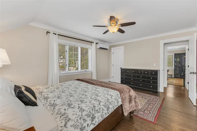 a bedroom with a large bed and a window