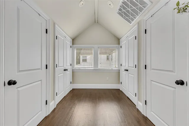 a view of walk in closet with wooden floor
