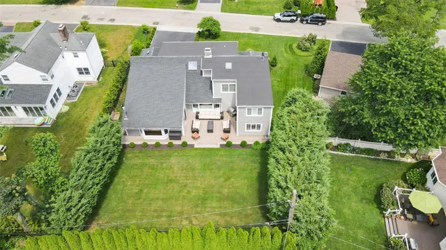an aerial view of residential houses with outdoor space and swimming pool
